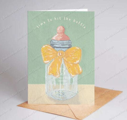 Greeting card with a baby bottle and bow design on a light green background