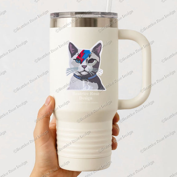 White tumbler with a cat design held by a hand on a white background