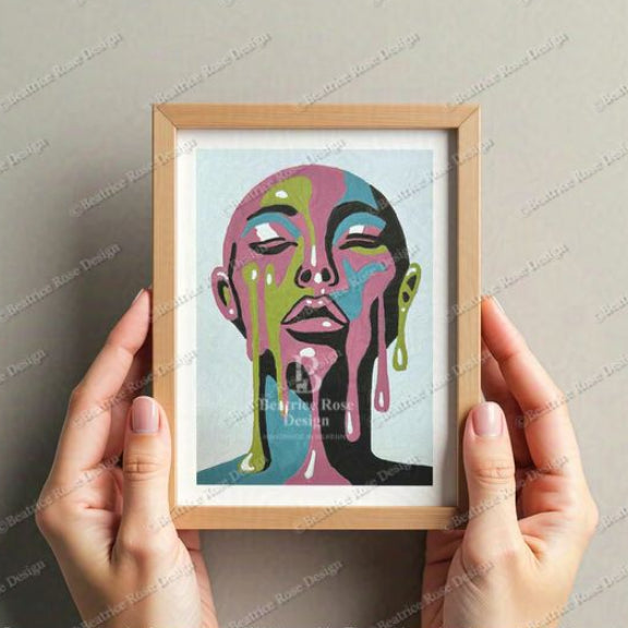 Framed colorful artwork of a face held by hands against a neutral background