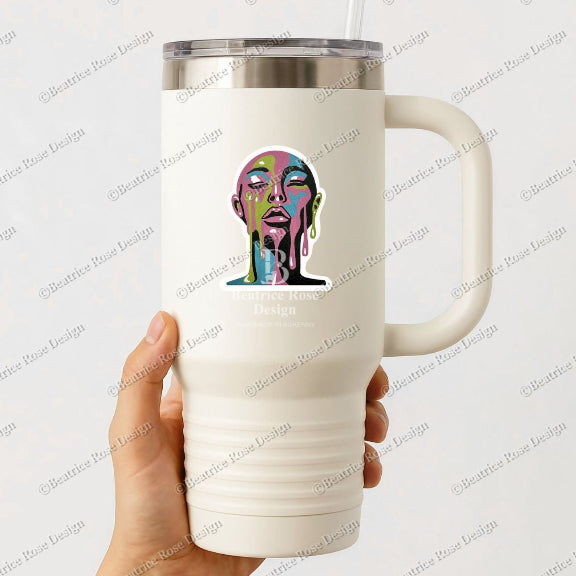 White travel mug with a colorful face design held by a hand on a light gray background