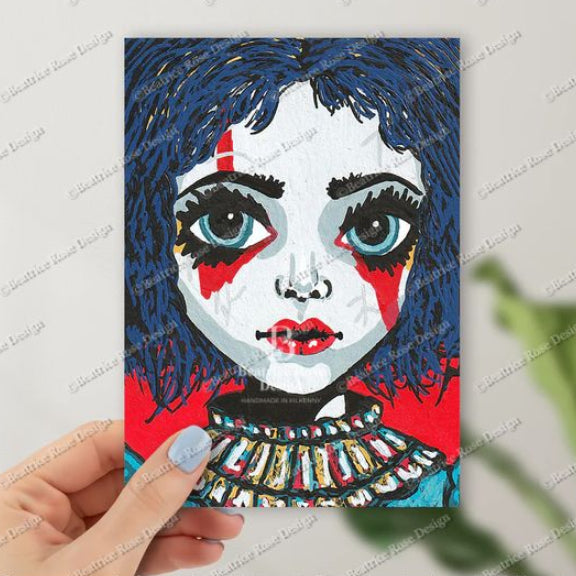 Artistic depiction of a face with blue hair and colorful makeup held by a hand.
